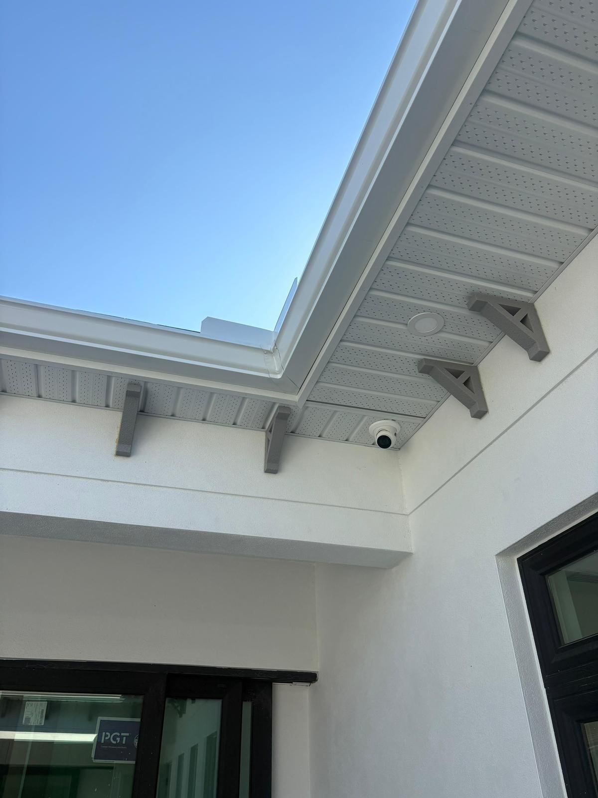 Professional white fascia and soffit replacement on a house